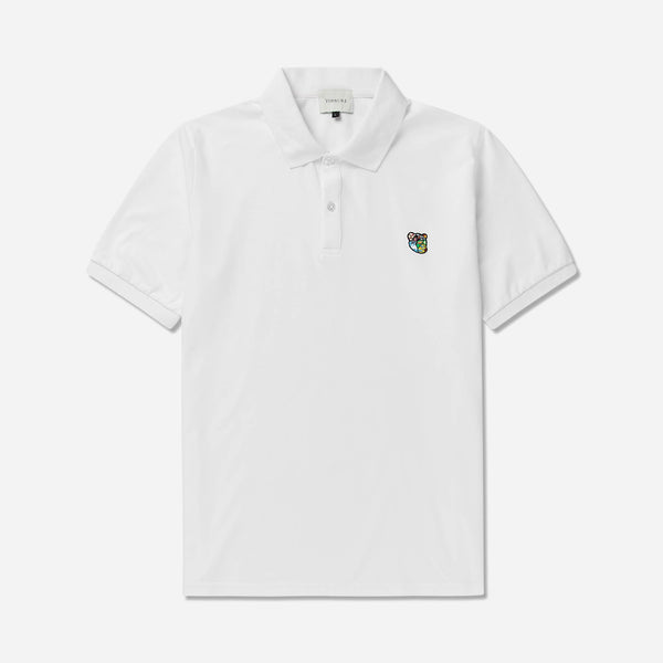 Polo shirt ss with round neck in a regular fit.  100% soft and light quality cotton, adorned with Tonsure teddy badge on the chest.  Color: White. Perfect for your basic wardrobe. Designed in Copenhagen by Tonsure